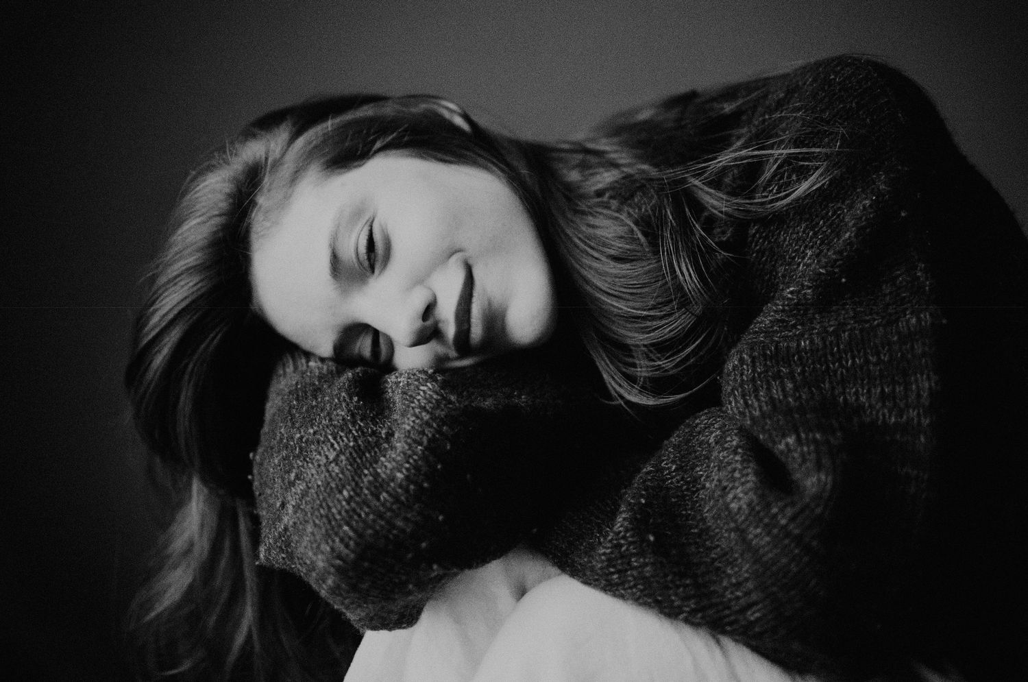 Artistic black and white portrait of someone in a cozy sweater with dramatic lighting in Los Angeles, CA.