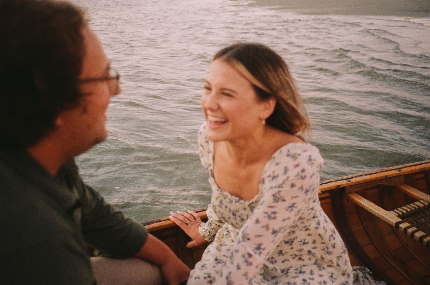 Couple sharing intimate moments while on a boat at sunset in Savannah, GA.