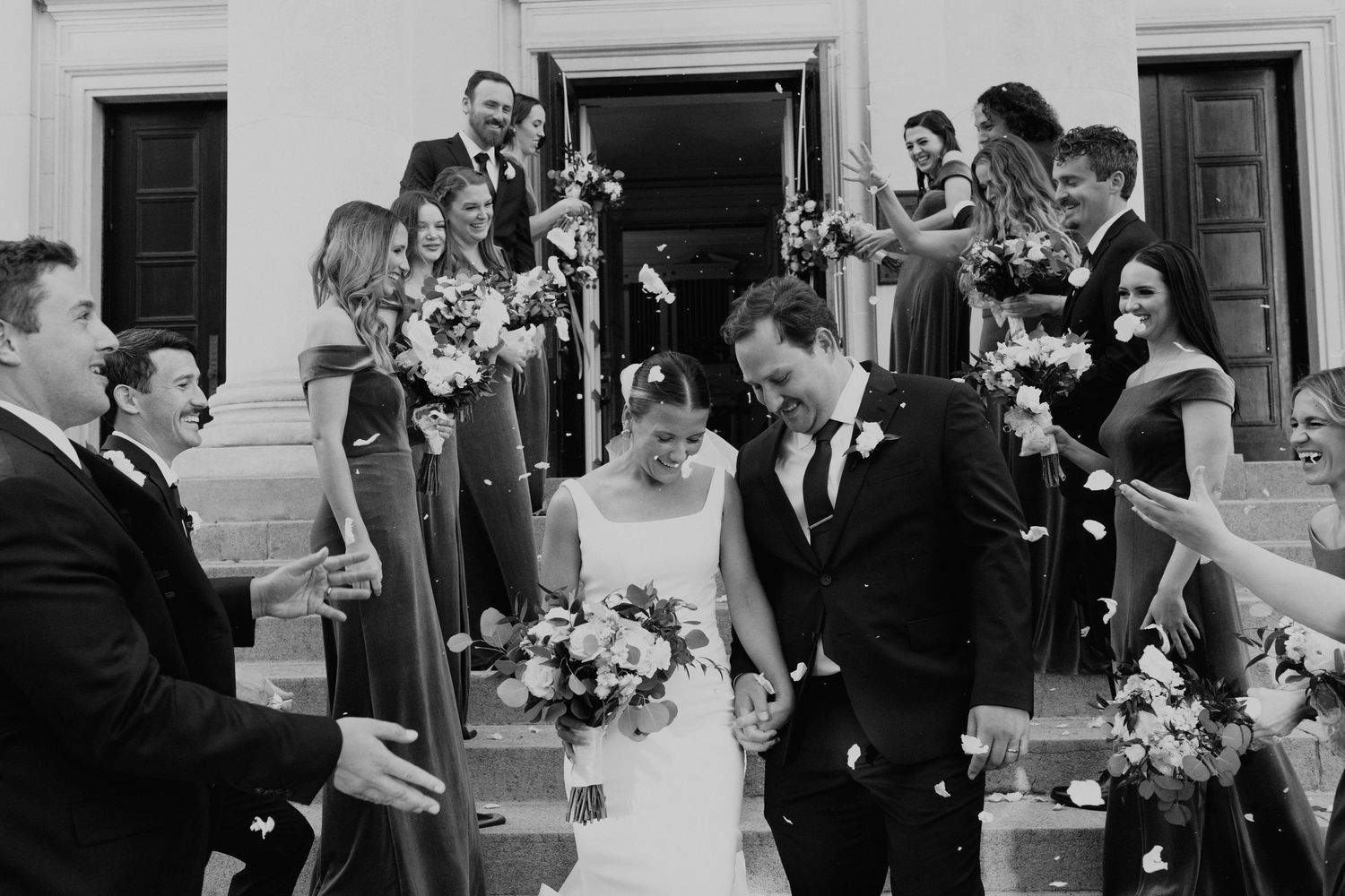 Wedding guests celebrate with confetti and sparklers outside a venue during a joyful celebration in Savannah, GA.