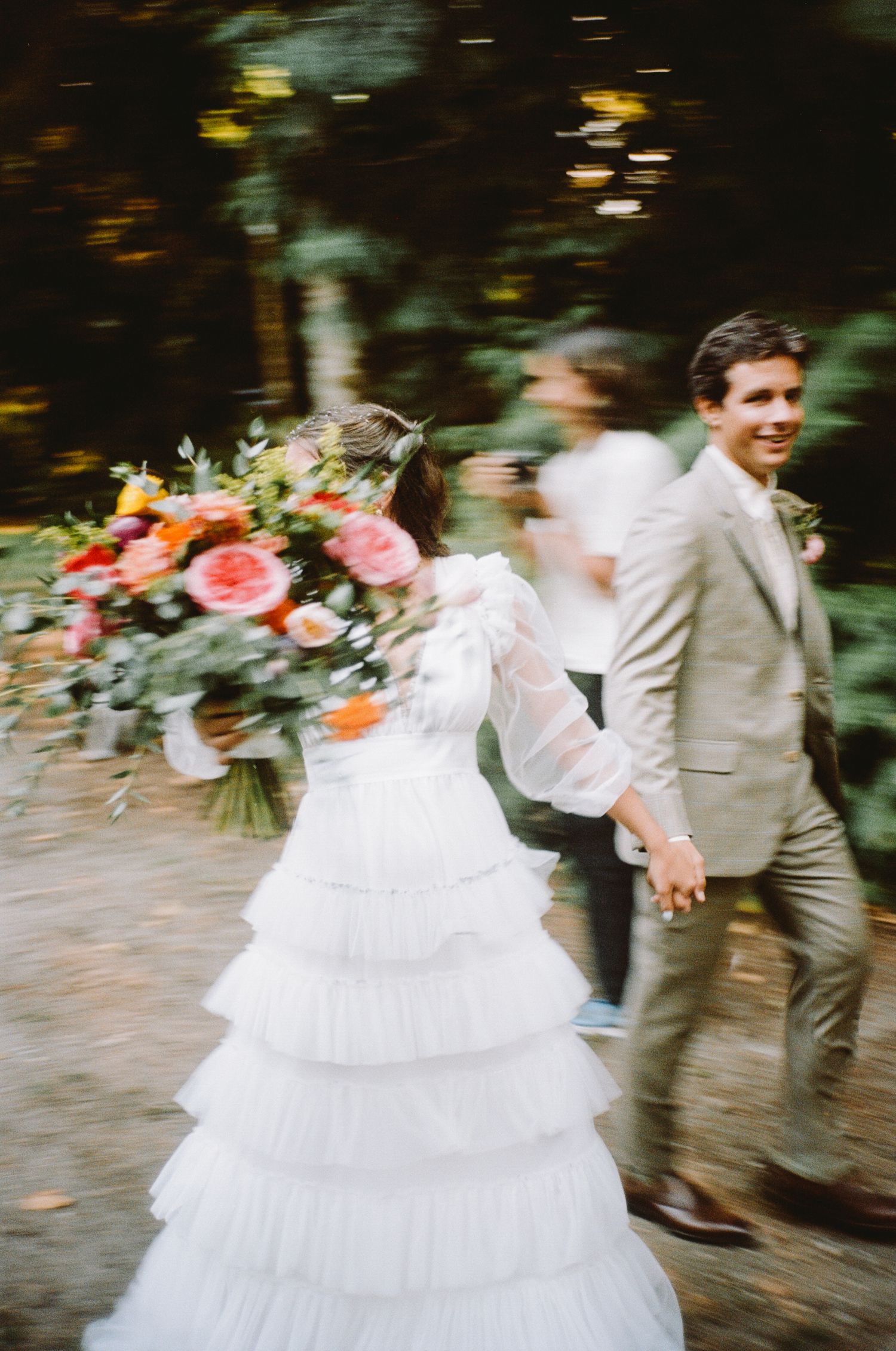 A joyful sequence of a bride in a white ruffled dress spinning and dancing at an outdoor wedding celebration in Los Angeles, CA.