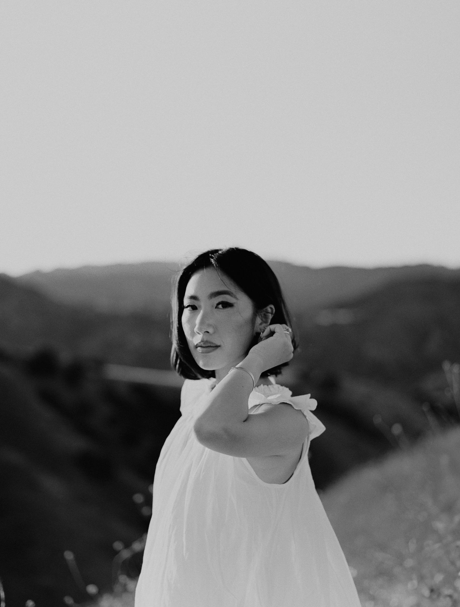 An artistic black and white portrait taken in a natural outdoor mountainous setting in Los Angeles, CA.