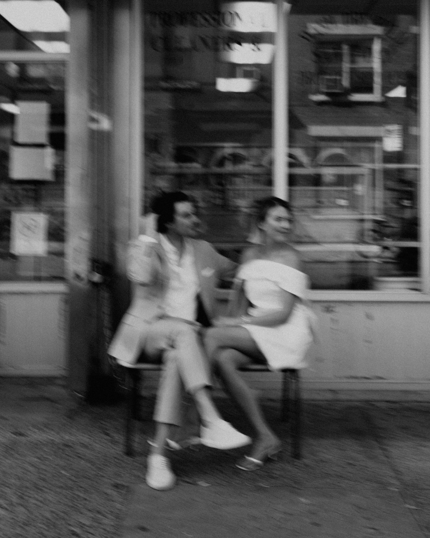 A blurred black and white street scene showing motion and movement in New York City.