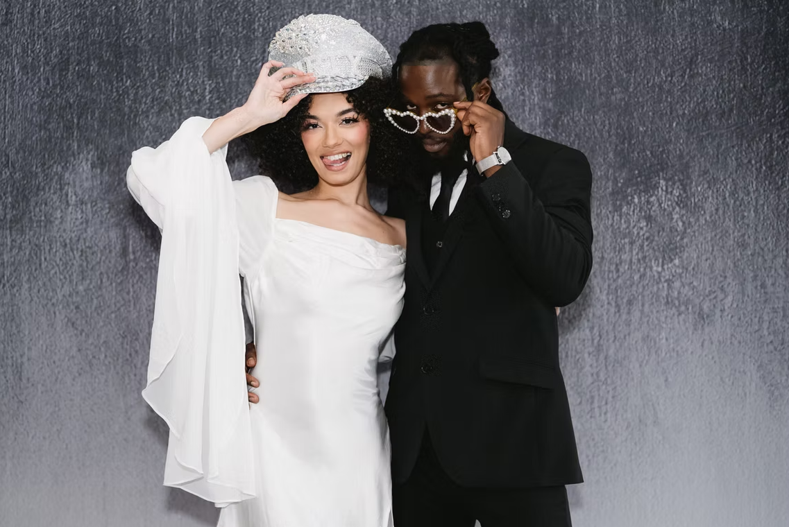 Couple in front of brushed backdrop.