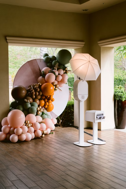 Photo booth with balloon backdrop.