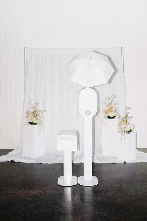 Photo booth with draped backdrop.