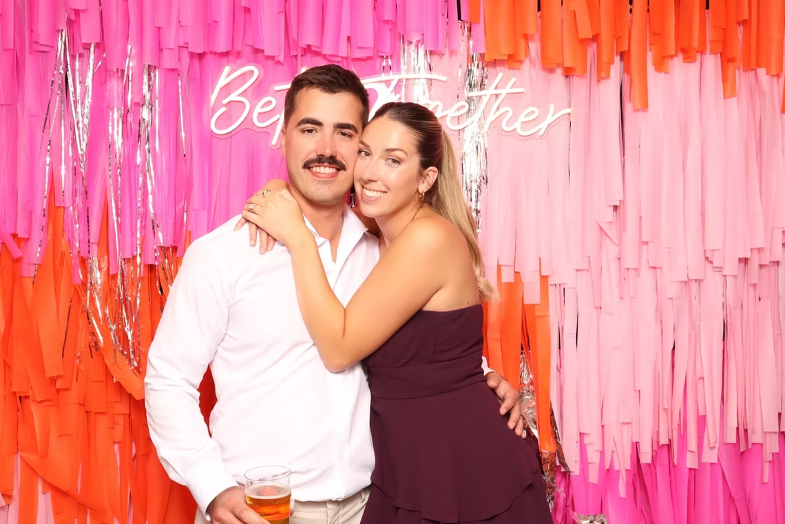 Couple in front of fringe backdrop.