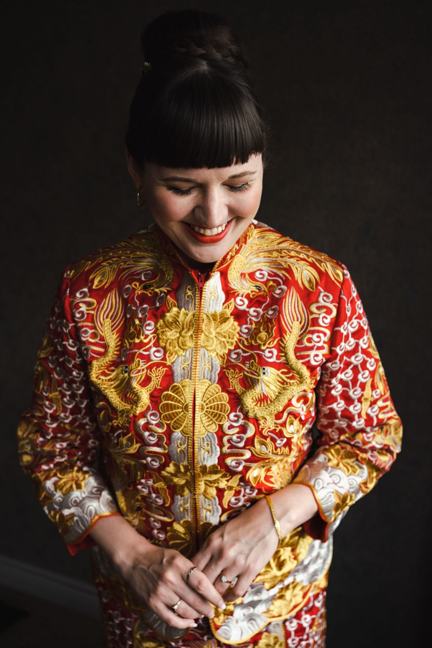 Westin Hotel downtown Toronto Harbour Waterfront. Bride in a traditional red Cheongsam Kipao Chinese Tea Ceremony with gold embellishment
