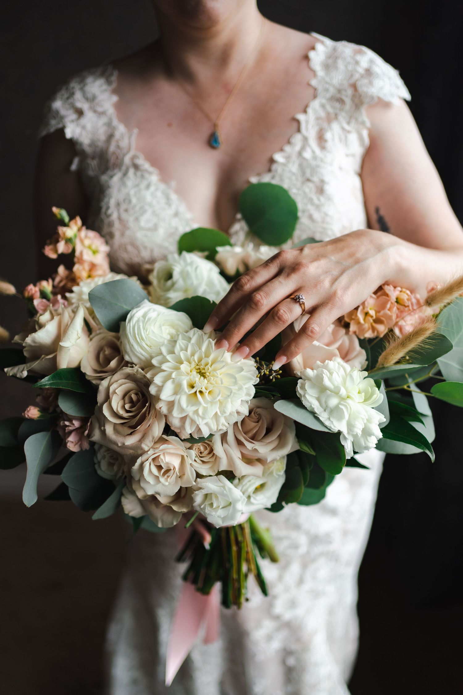 Westin Hotel in downtown Toronto Harbourfront waterfront. Bride in a lace dress with flowers consisting of eucalyptus, roses, and florals