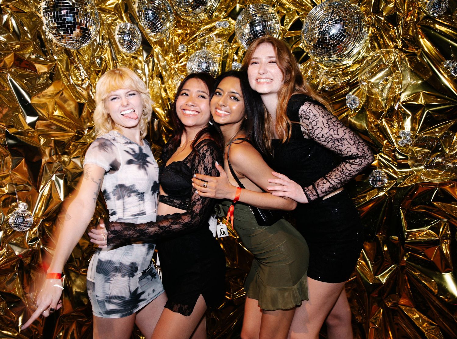 Party celebration with gold metallic backdrop and festive lighting.