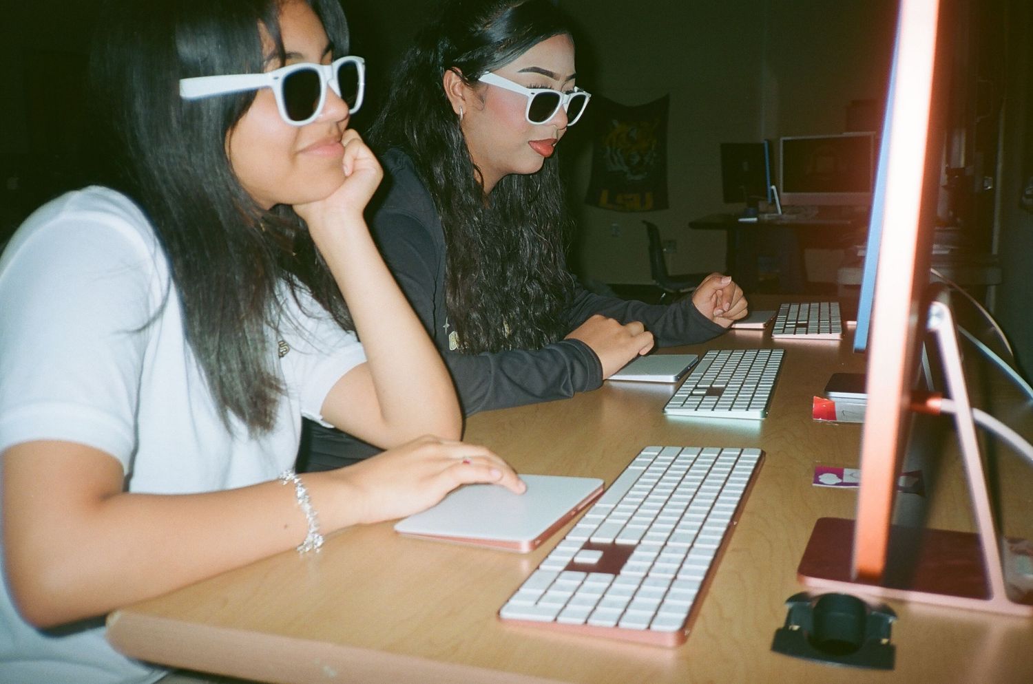A series of four photos showing someone working at a computer desk with a keyboard and red ambient lighting.