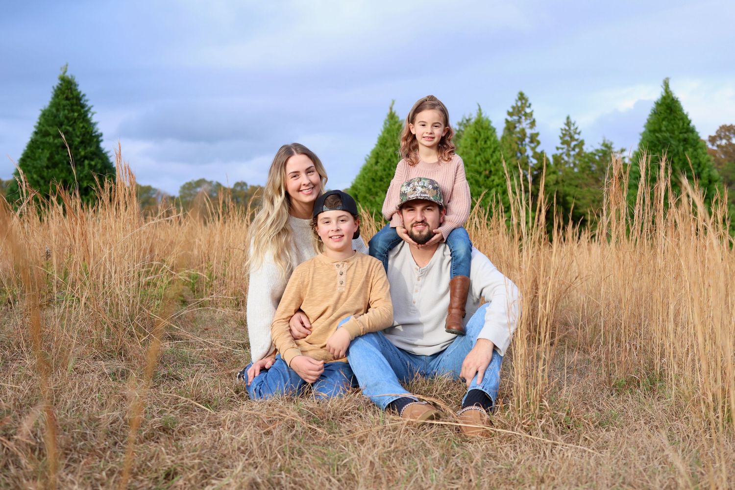 Family portrait in a field with long grass