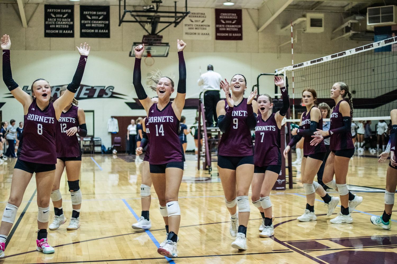 Hudson hornet volleyball cheering after a win.