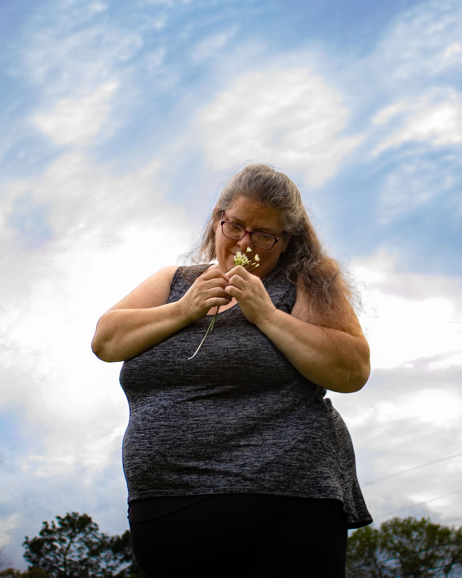 A photo made by shotz.by.jah of a woman holding flowers