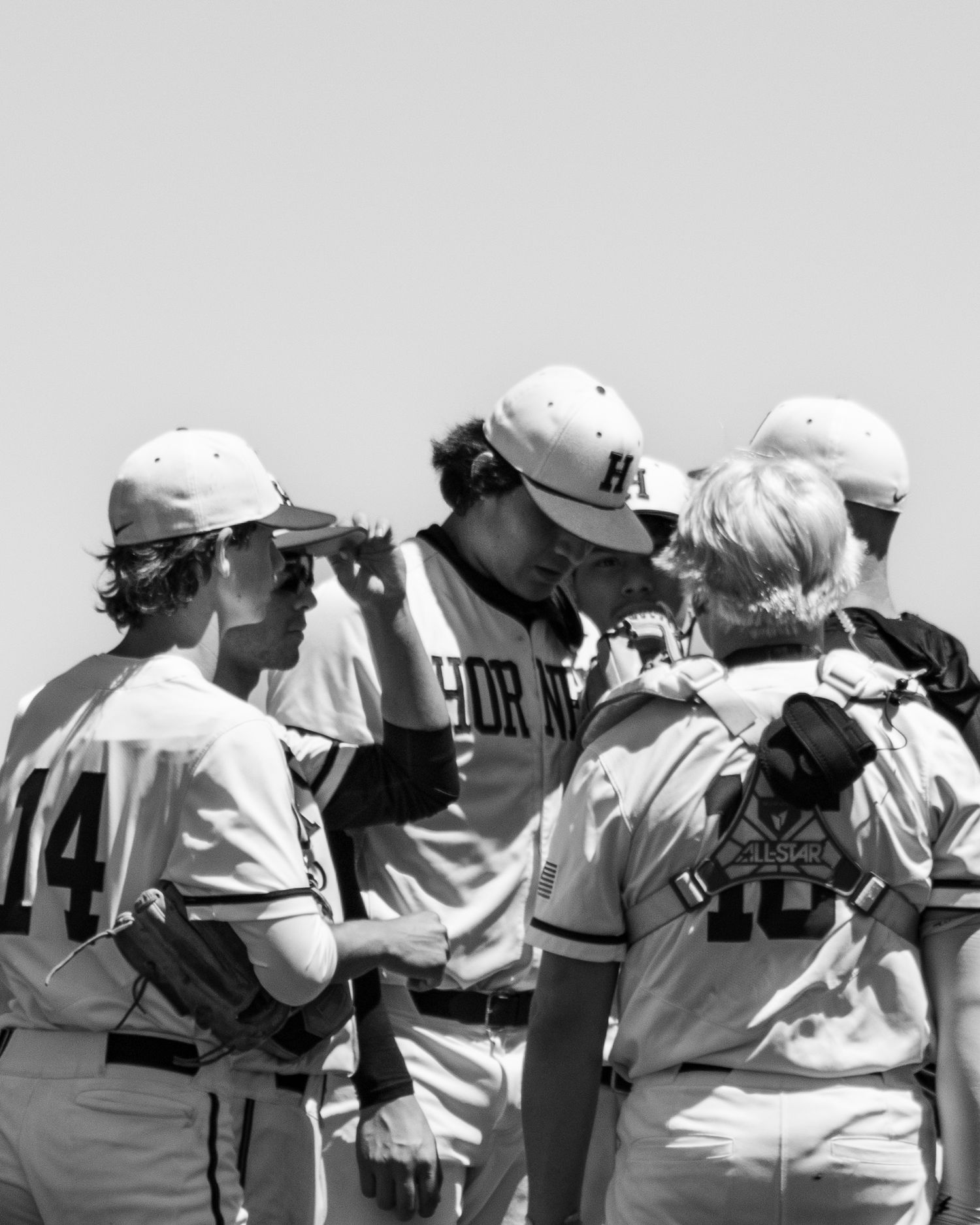 A photo made by shotz.by.jah of a baseball mound visit with beto ibarra as the focus of the picture
