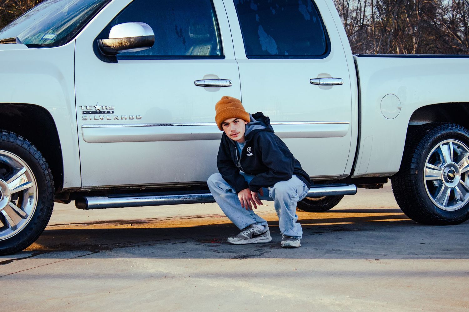 A photo made by Shotz.By.Jah of a man standing by his car