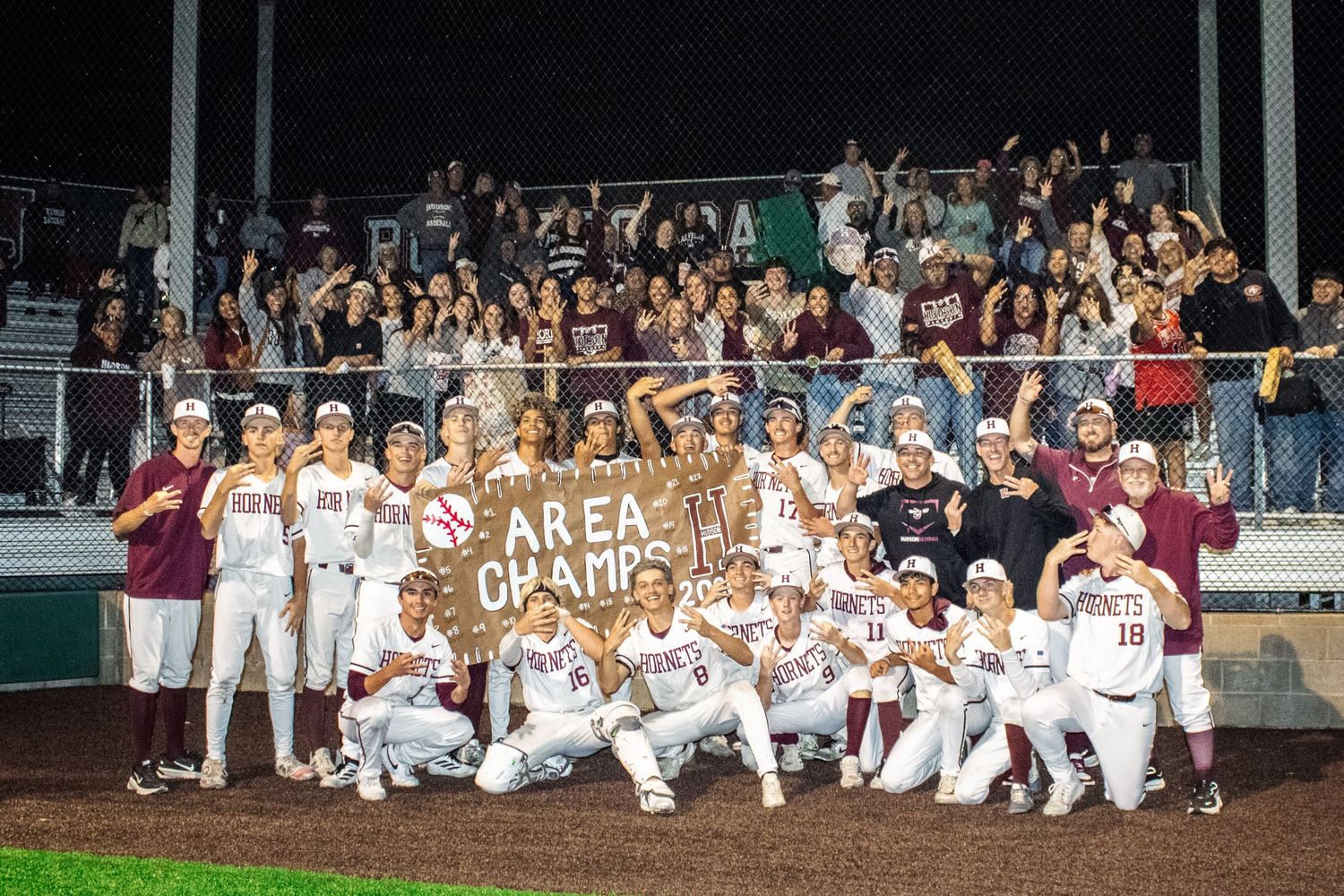 A photo made by shotz.by.jah of a team and fans of a highschool baseball team from Hudson High school cheering
