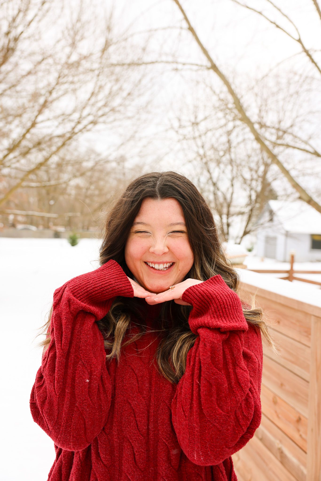 Winter portrait series featuring someone in a red sweater making cheerful expressions.