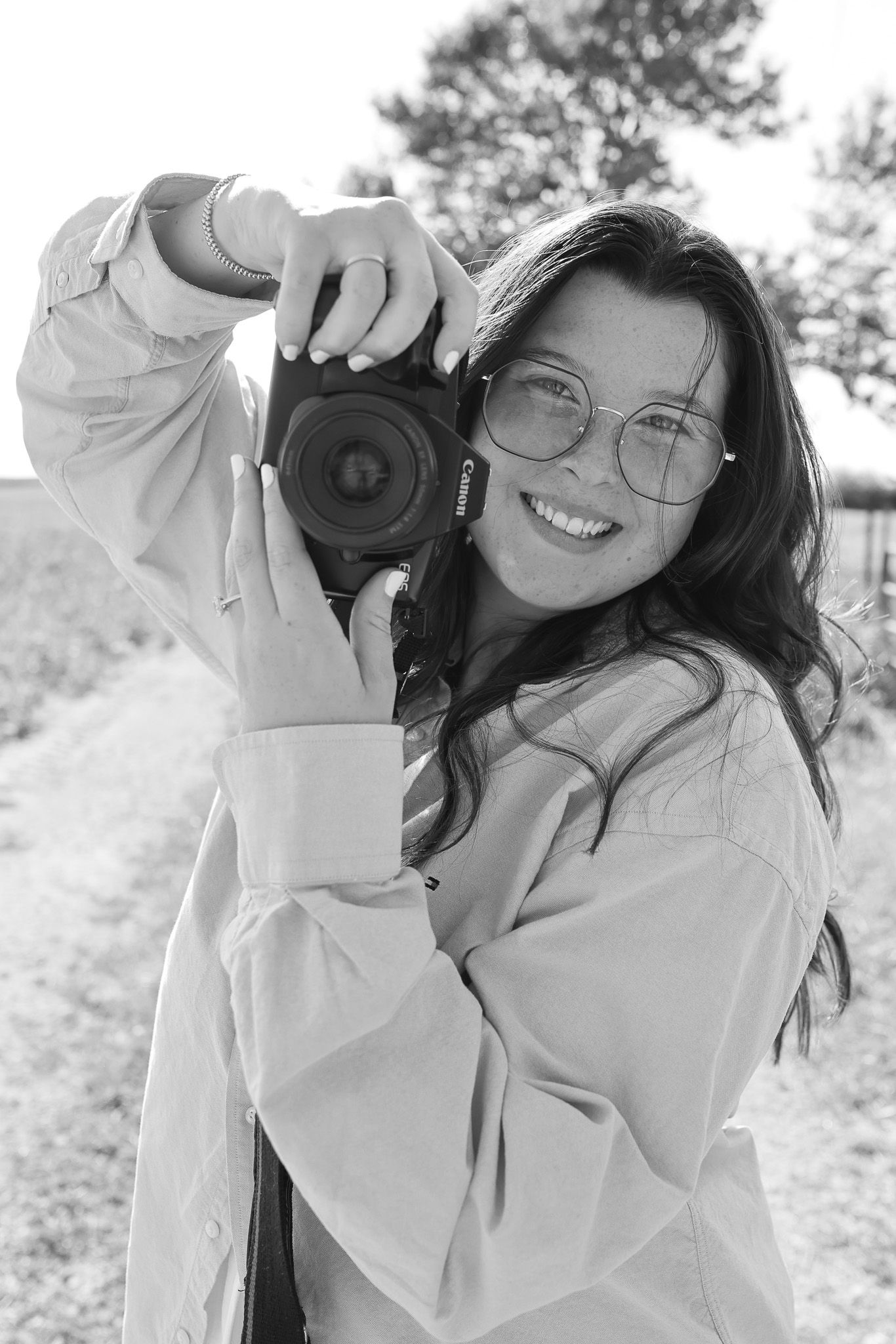 Black and white portraits showing joyful moments with a camera in natural lighting.