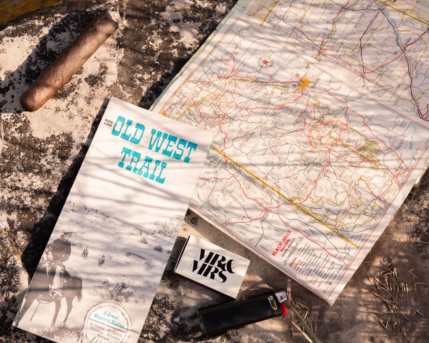 Old West Park map and compass laid out on weathered wooden surface.