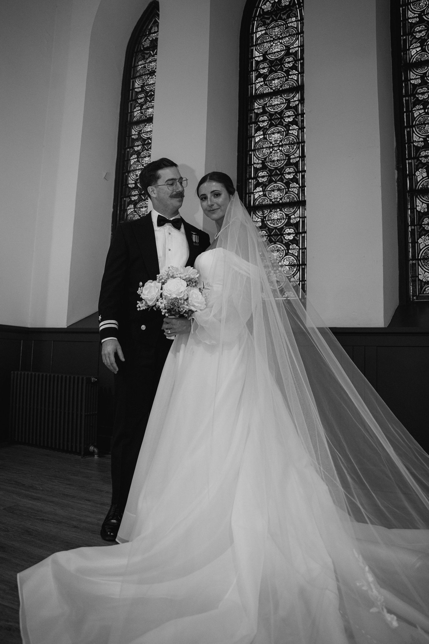 A romantic black and white wedding photo sequence showing a couple sharing intimate moments in an elegant church setting.