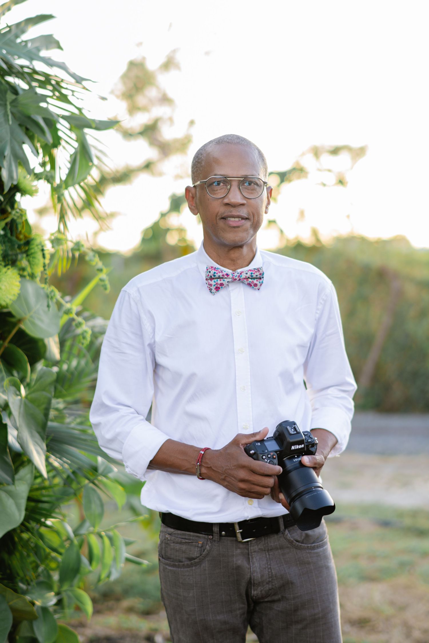 photographe de mariage avec un boitier nikon et un noeud papillon.