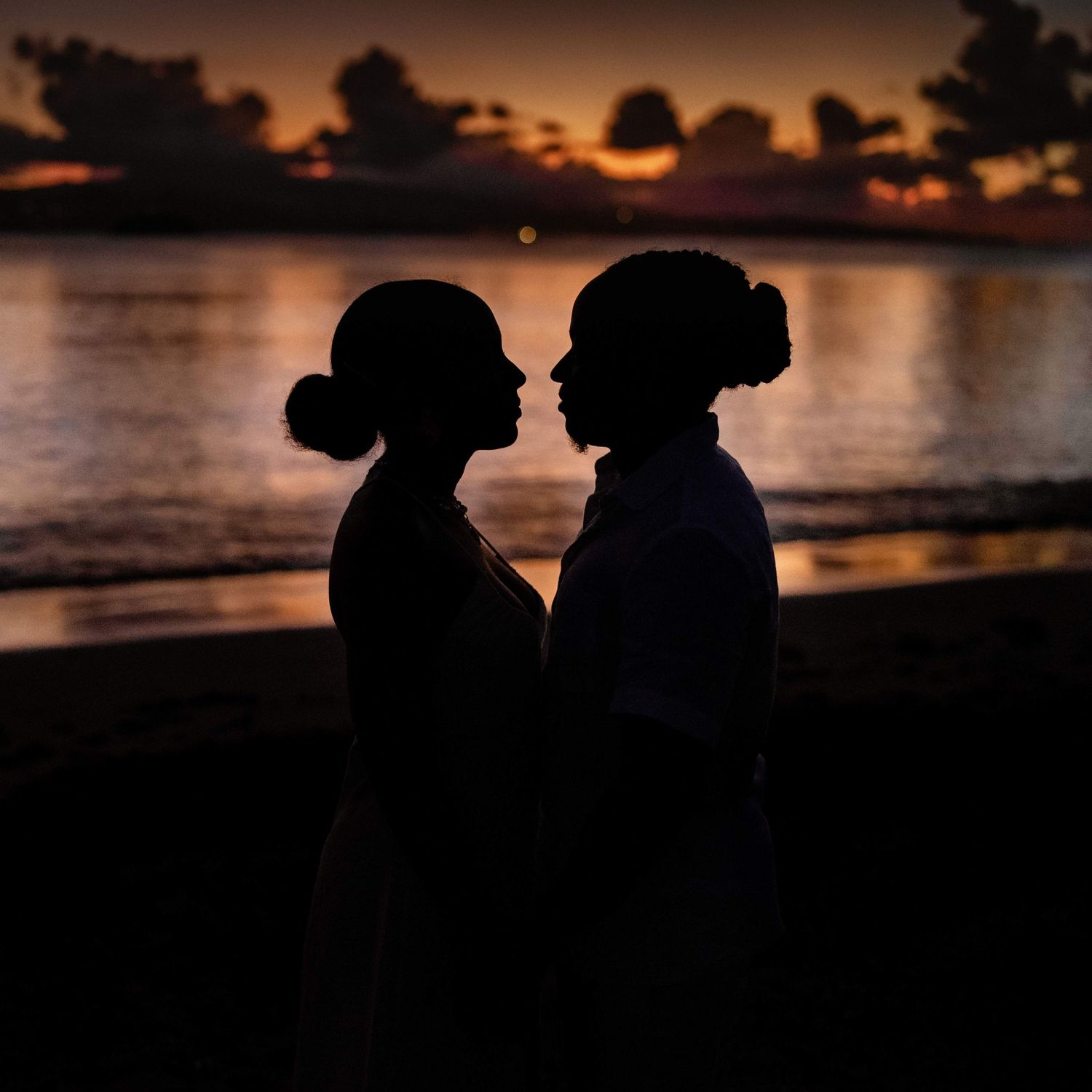 Silhouette de couple en martinique au coucher de soleil sur une plage de trinité.