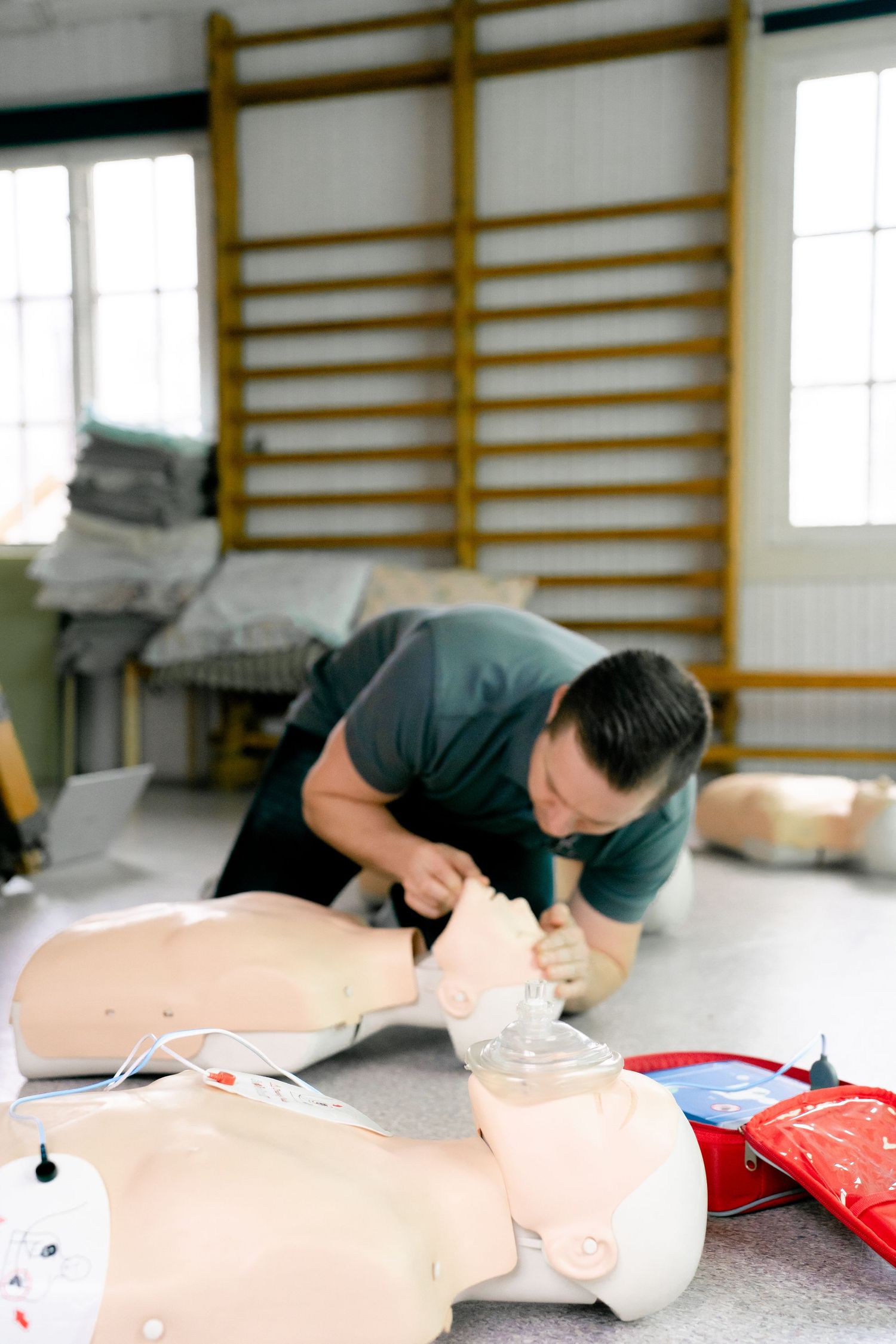 Healthcare training session with CPR mannequin demonstration.
