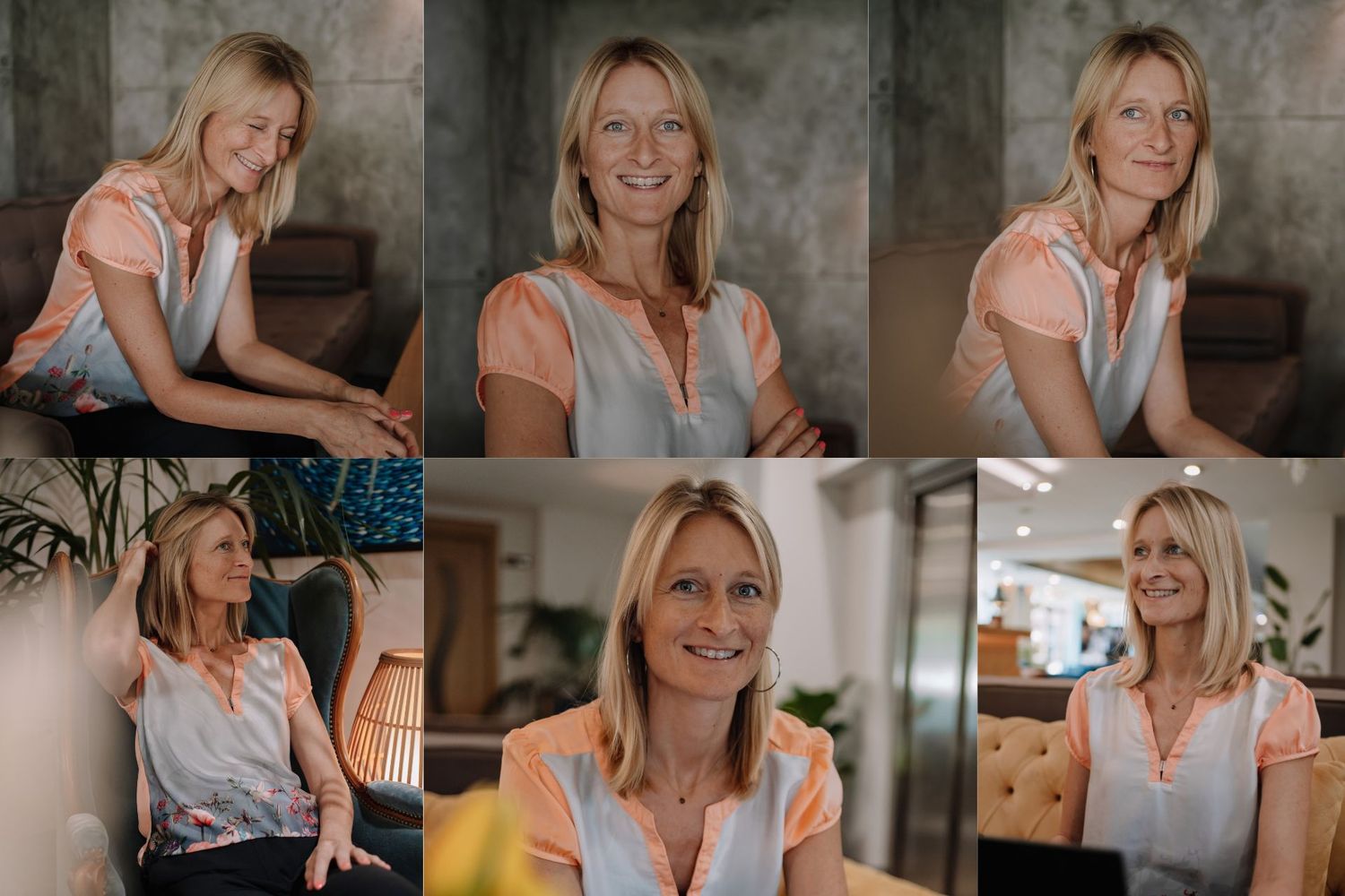 Smiling blonde woman in a gray and peach blouse posing confidently in a modern office setting.