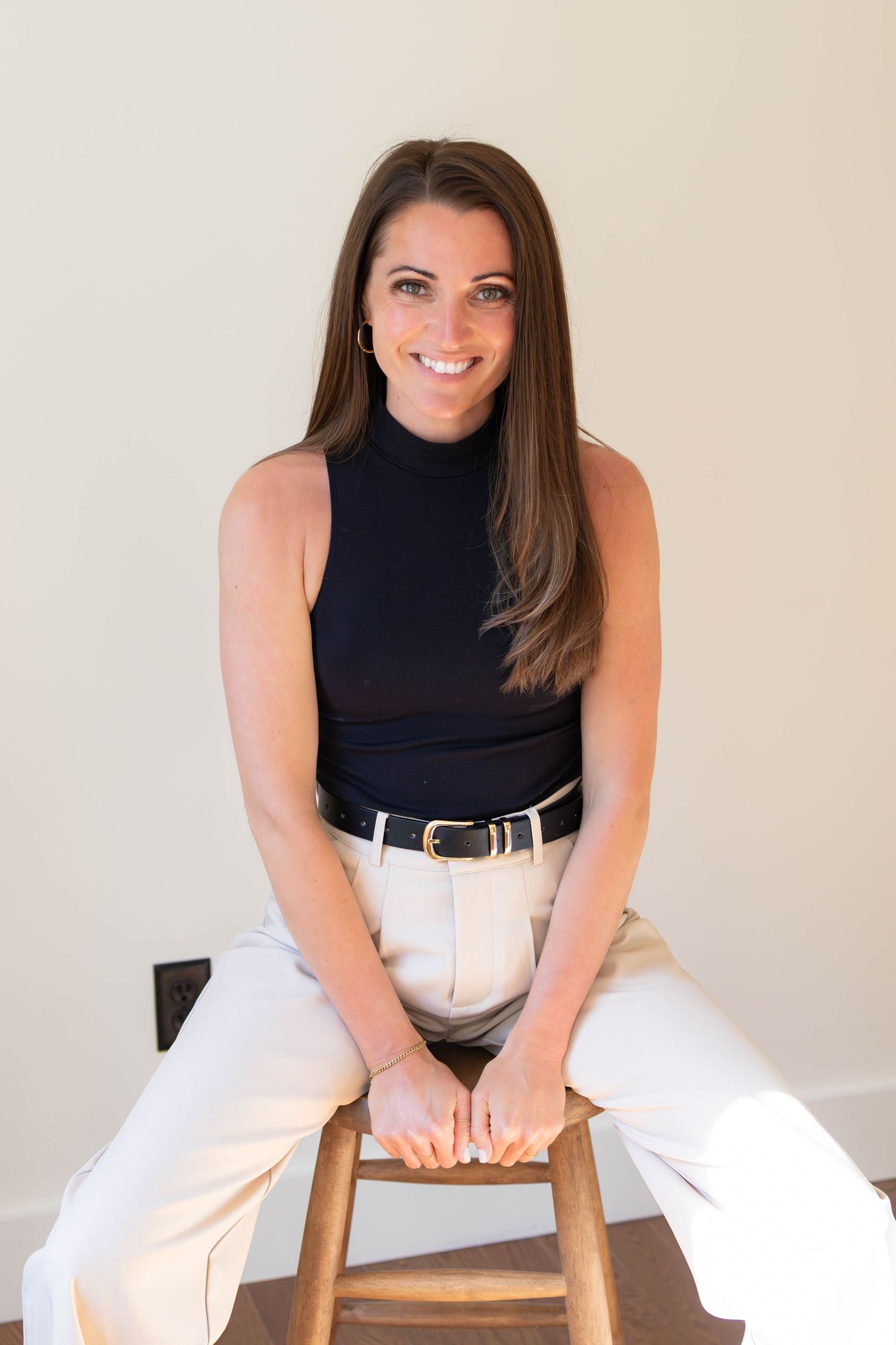 Branding portrait of a small business owner seated in a bright studio space.