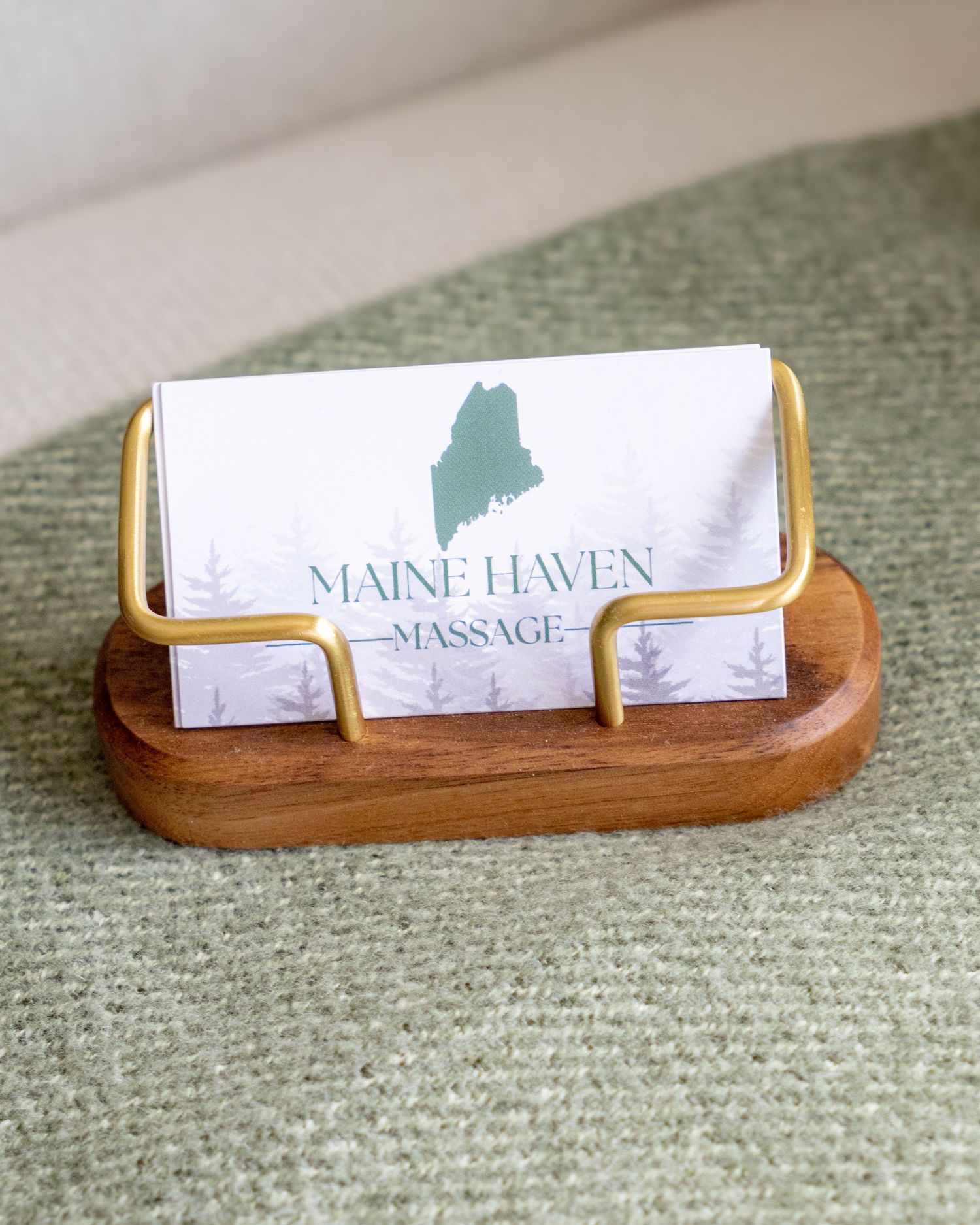 Branding detail photo of Maine Haven Massage business cards on a textured blanket
