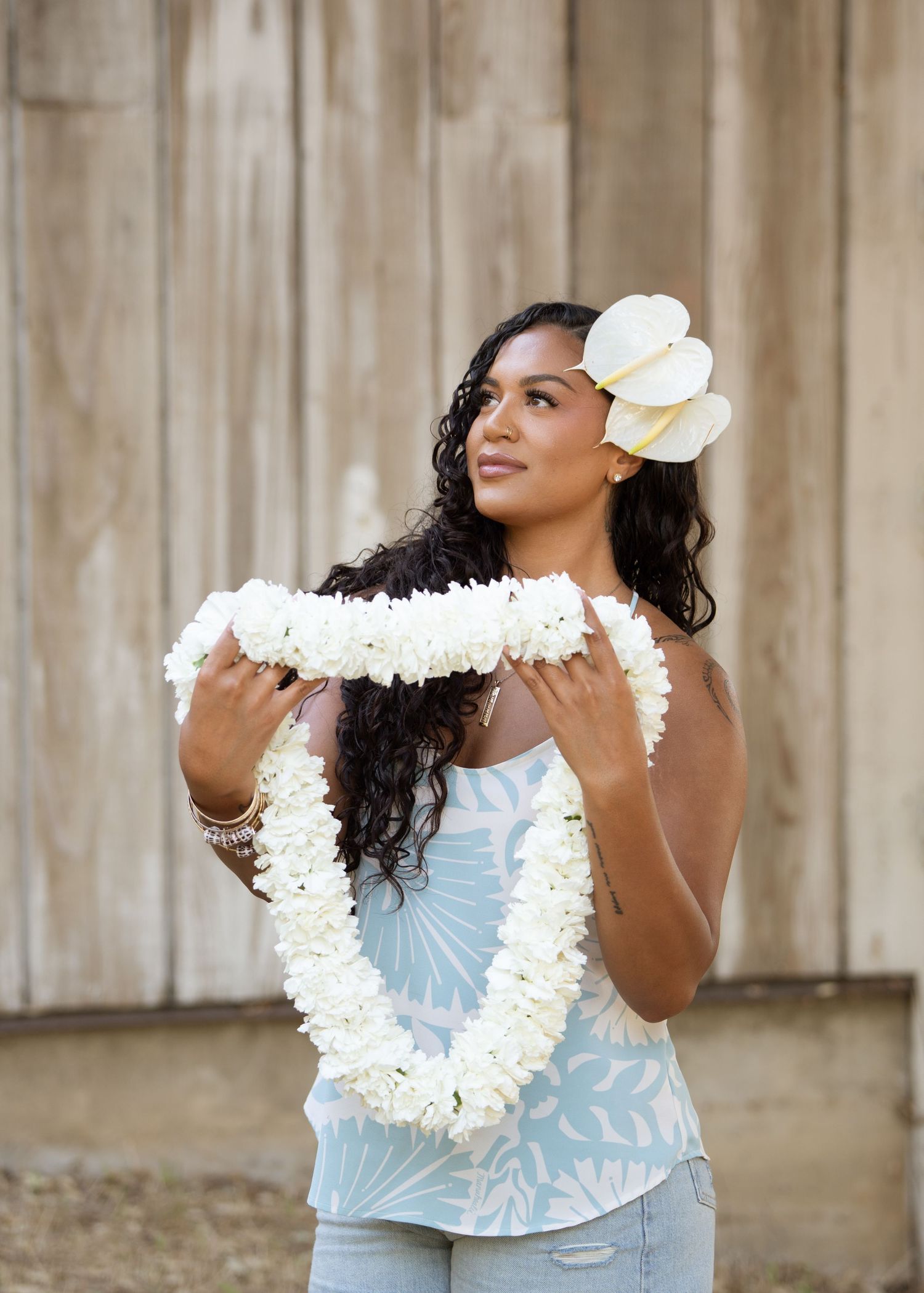 Kiana modeling the 75 stem single strand lei with 2 beautiful anthurium on her ear