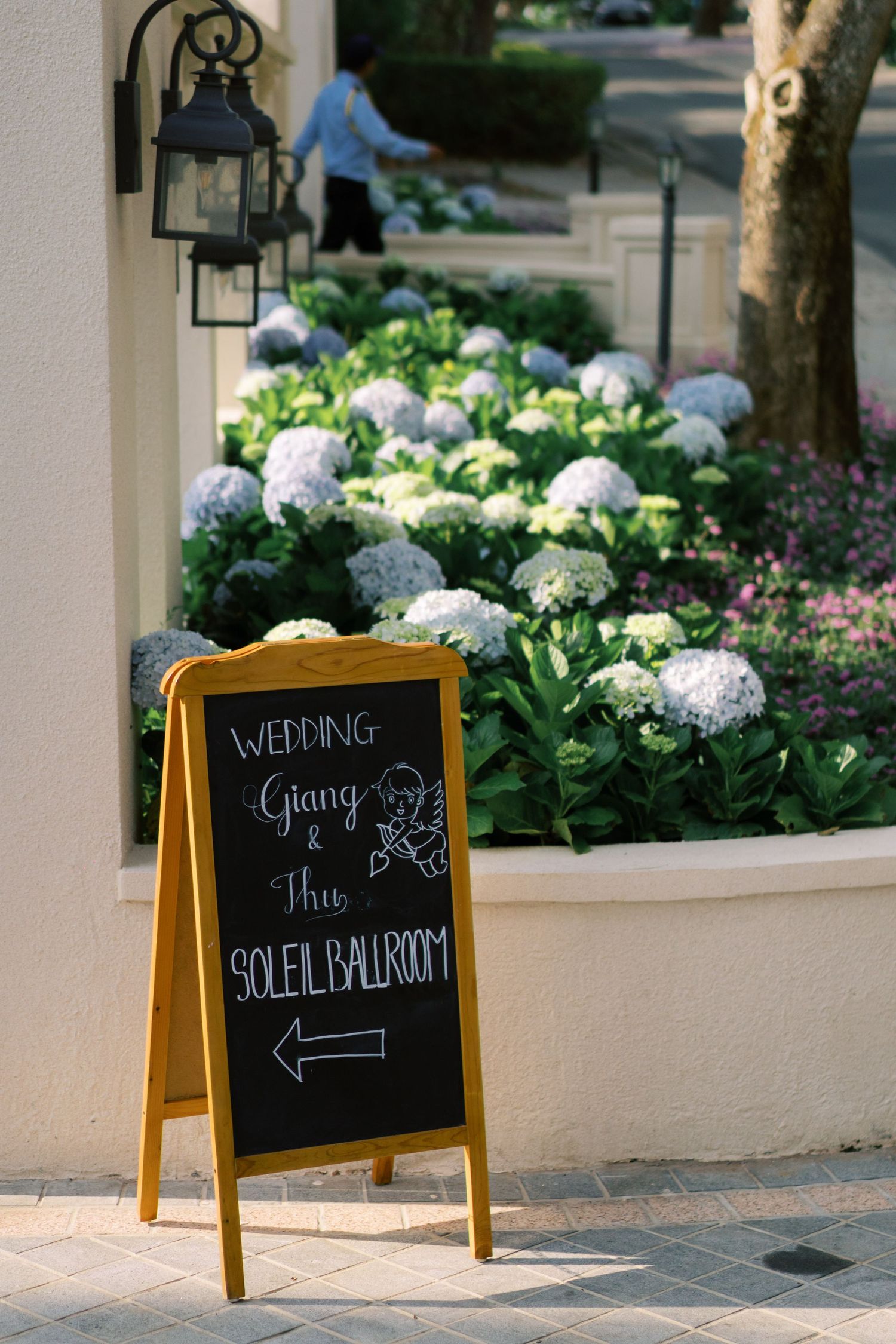 Wedding sign on a chalkboard easel directing guests to the Soleil Ballroom for Giang and Thu's wedding ceremony.