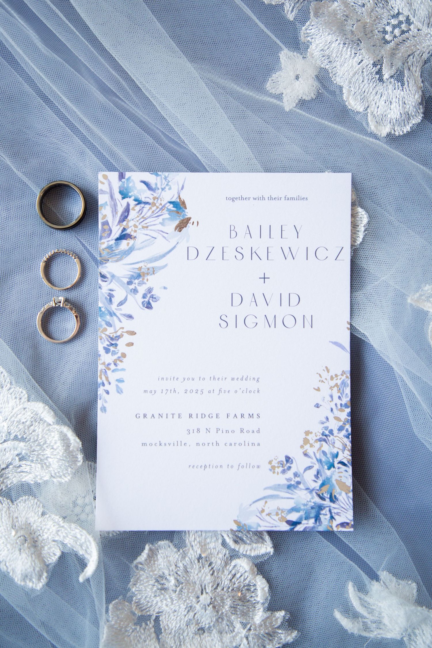 Wedding invitation for Bailey Dzeskewicz and David Sigmon at Granite Ridge Farms with rings and blue veil.
