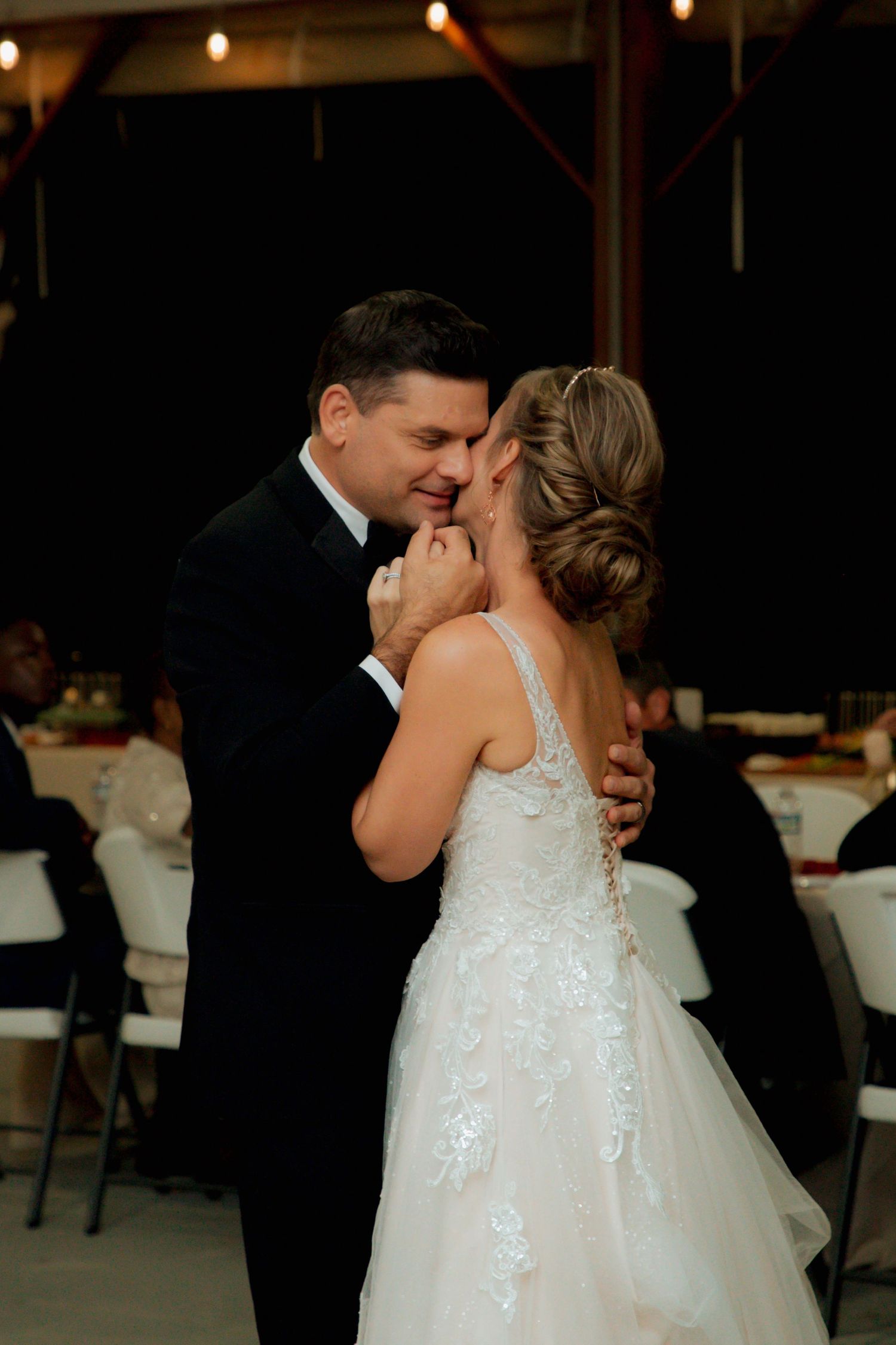 Bride and groom share an intimate first dance moment at their wedding reception.