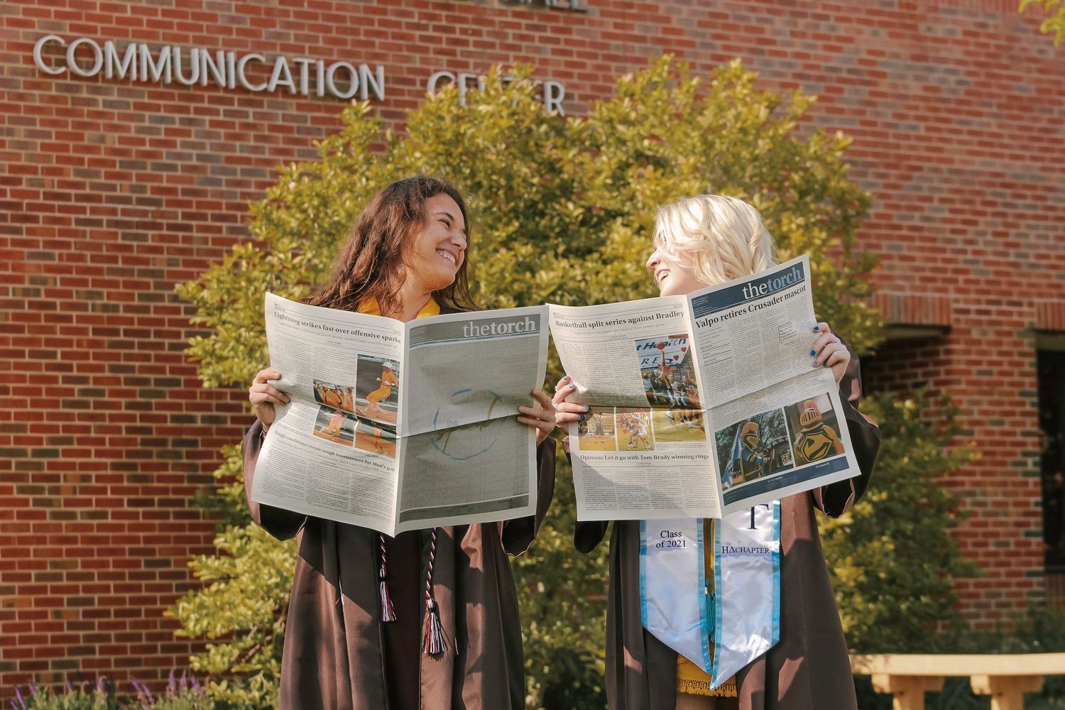 two women posing with newspaper at Valparaiso university