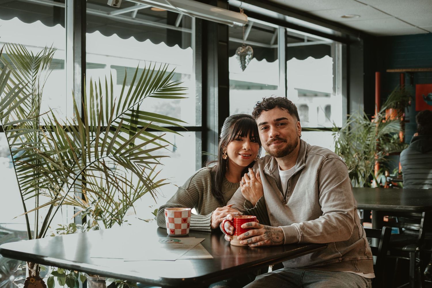 Couple sitting together in cafe with coffee.