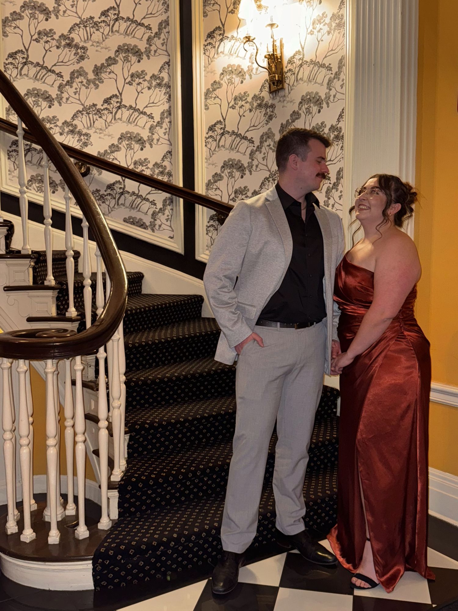 Man and woman pose on spiral staircase at Michigan Wedding.