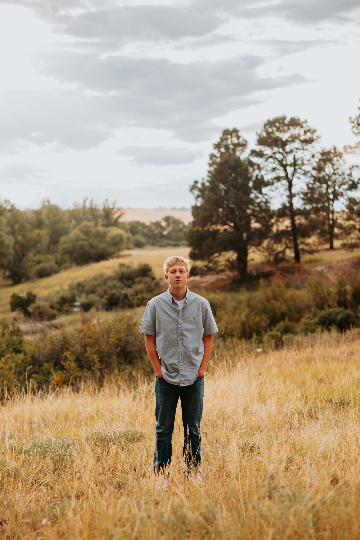 Confident senior guy stands tall against Colorado’s stunning backdrop, ready to take on the future with a bold, adventurous spirit.