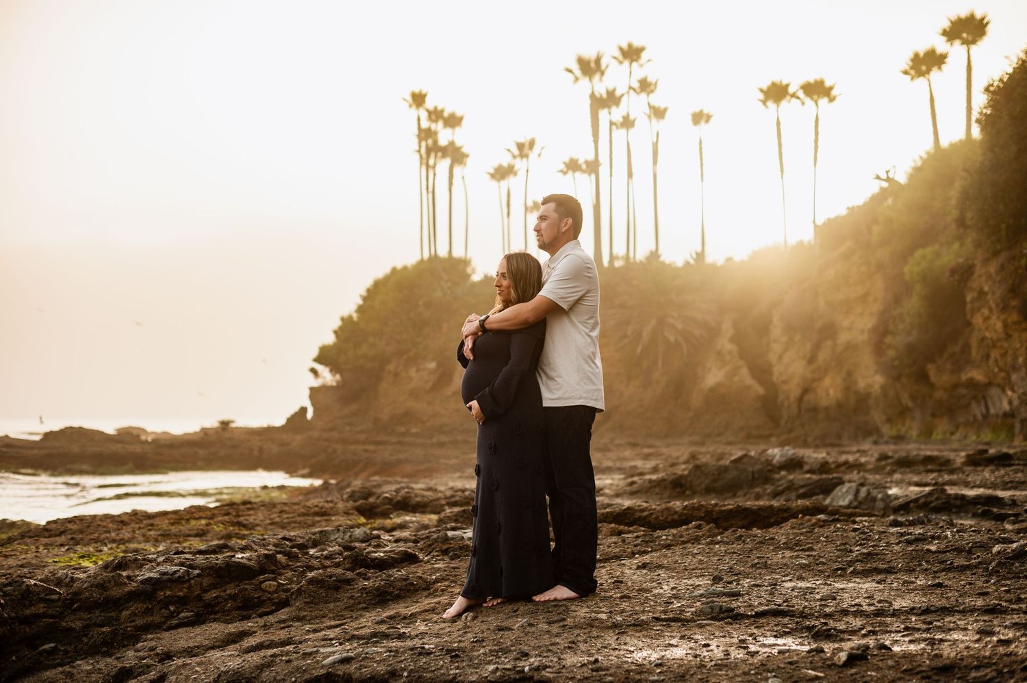 Romantic engagement photo of couple during golden hour at Newport Beach with an ocean background. maternity photos laguna beach