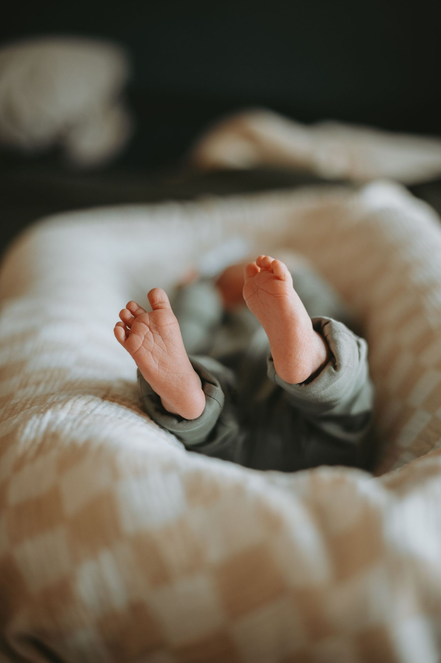 A cozy in-home newborn session in Denver, capturing the tender moments between parents and their precious little one. Soft, natural light