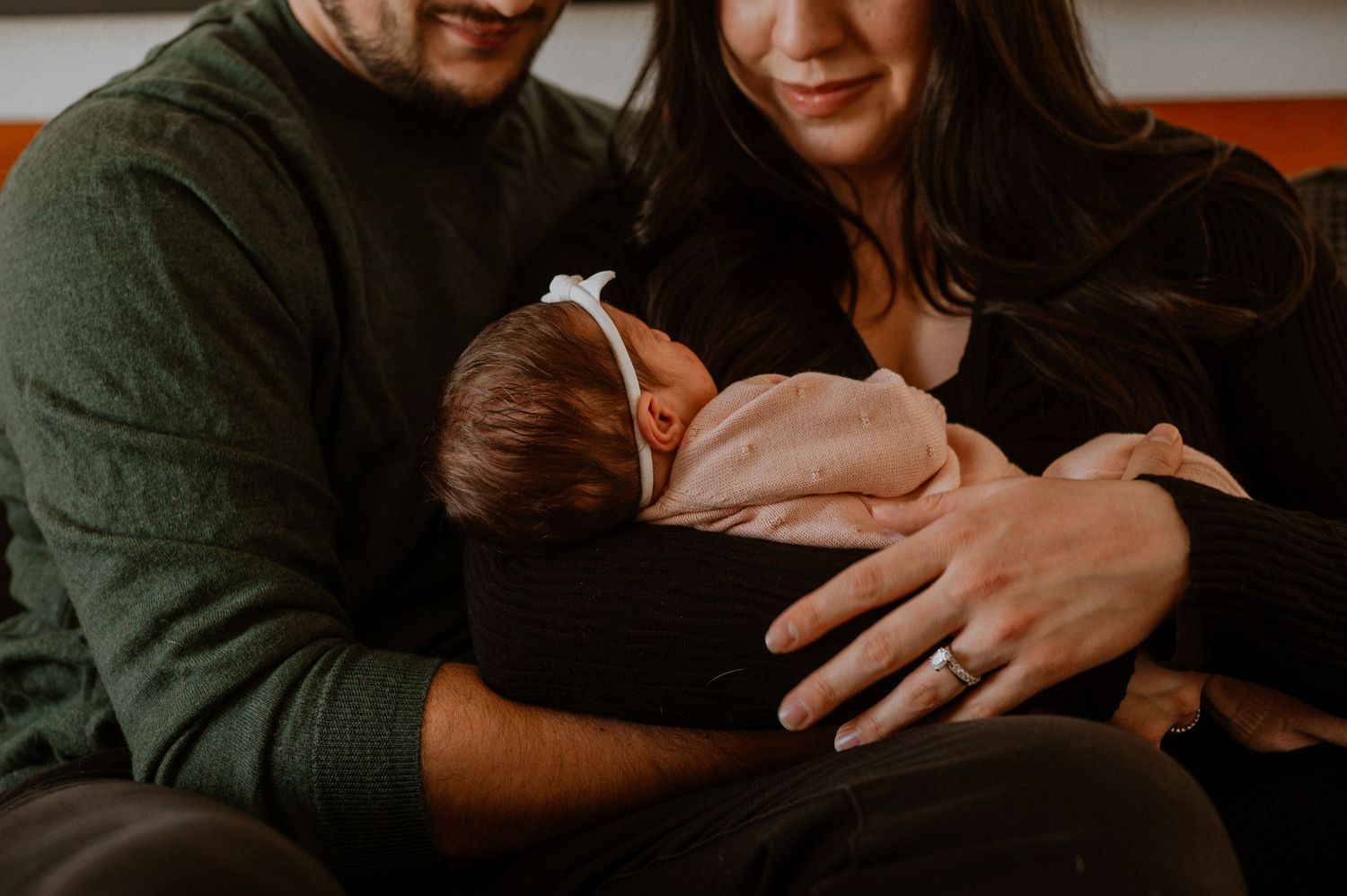 A cozy in-home newborn session in Denver, capturing the tender moments between parents and their precious little one. Soft, natural light fi