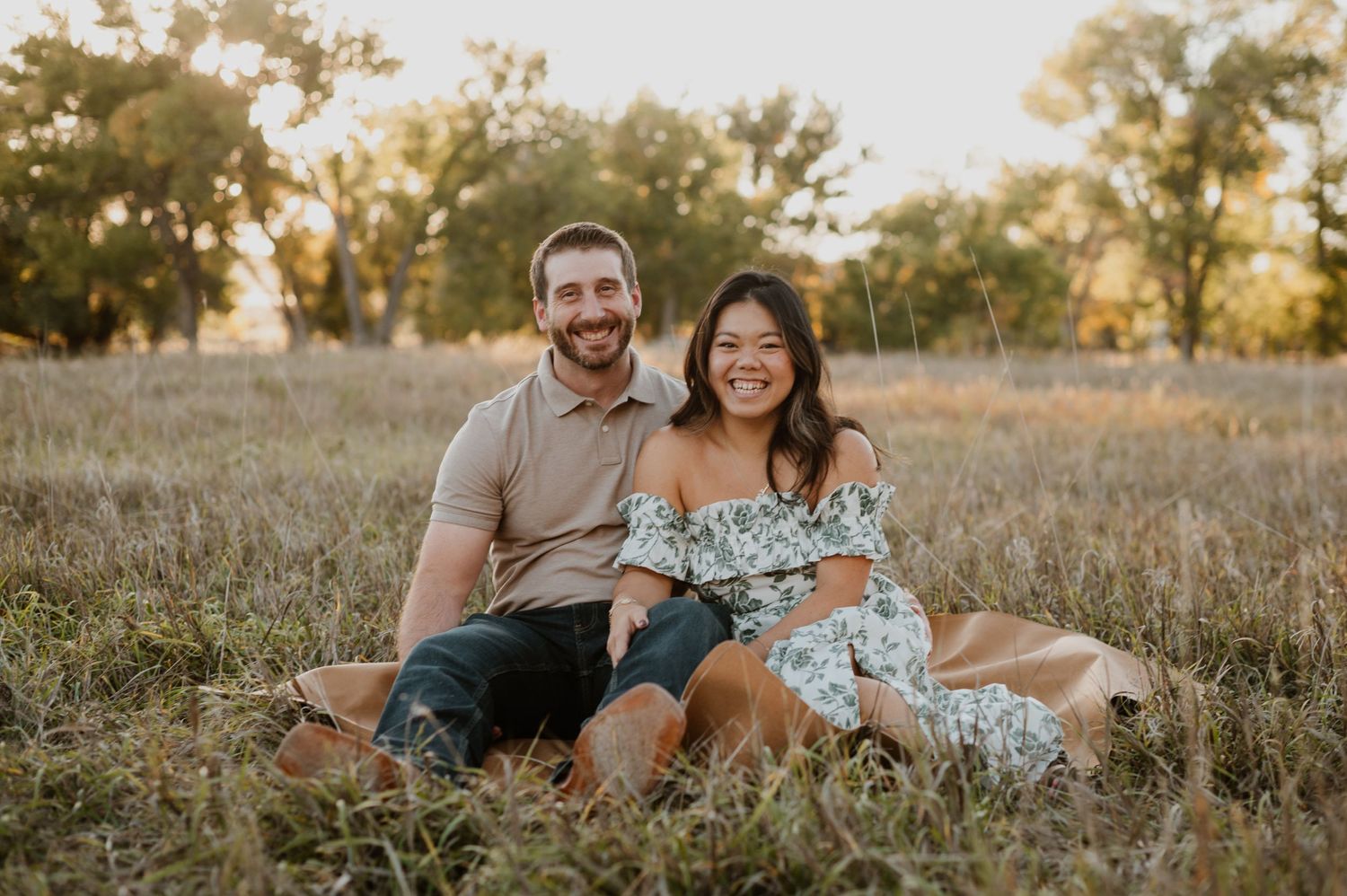 A loving family embraces golden hour in Castle Rock, Colorado, with warm sunlight highlighting their bond against a breathtaking, peaceful b