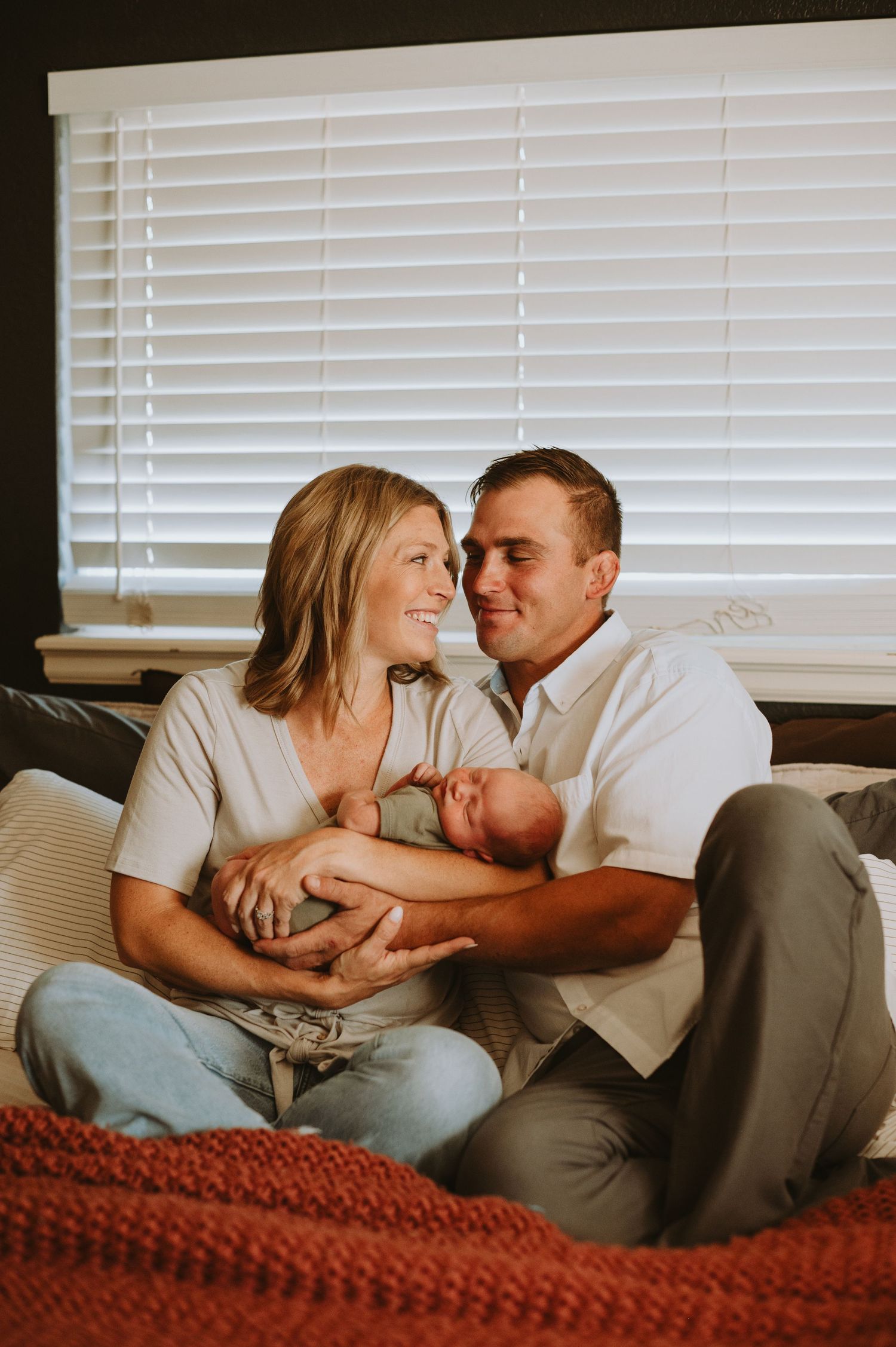 A cozy in-home newborn session in Denver, capturing the tender moments between parents and their precious little one. Soft, natural light