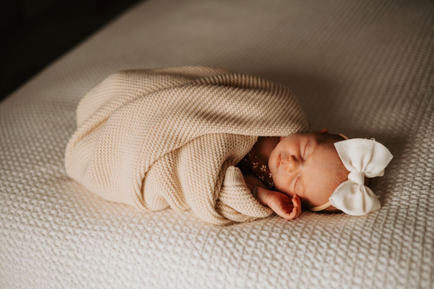 Newborn peacefully resting at home, wrapped in warmth and love—capturing the quiet beauty of these first precious moments