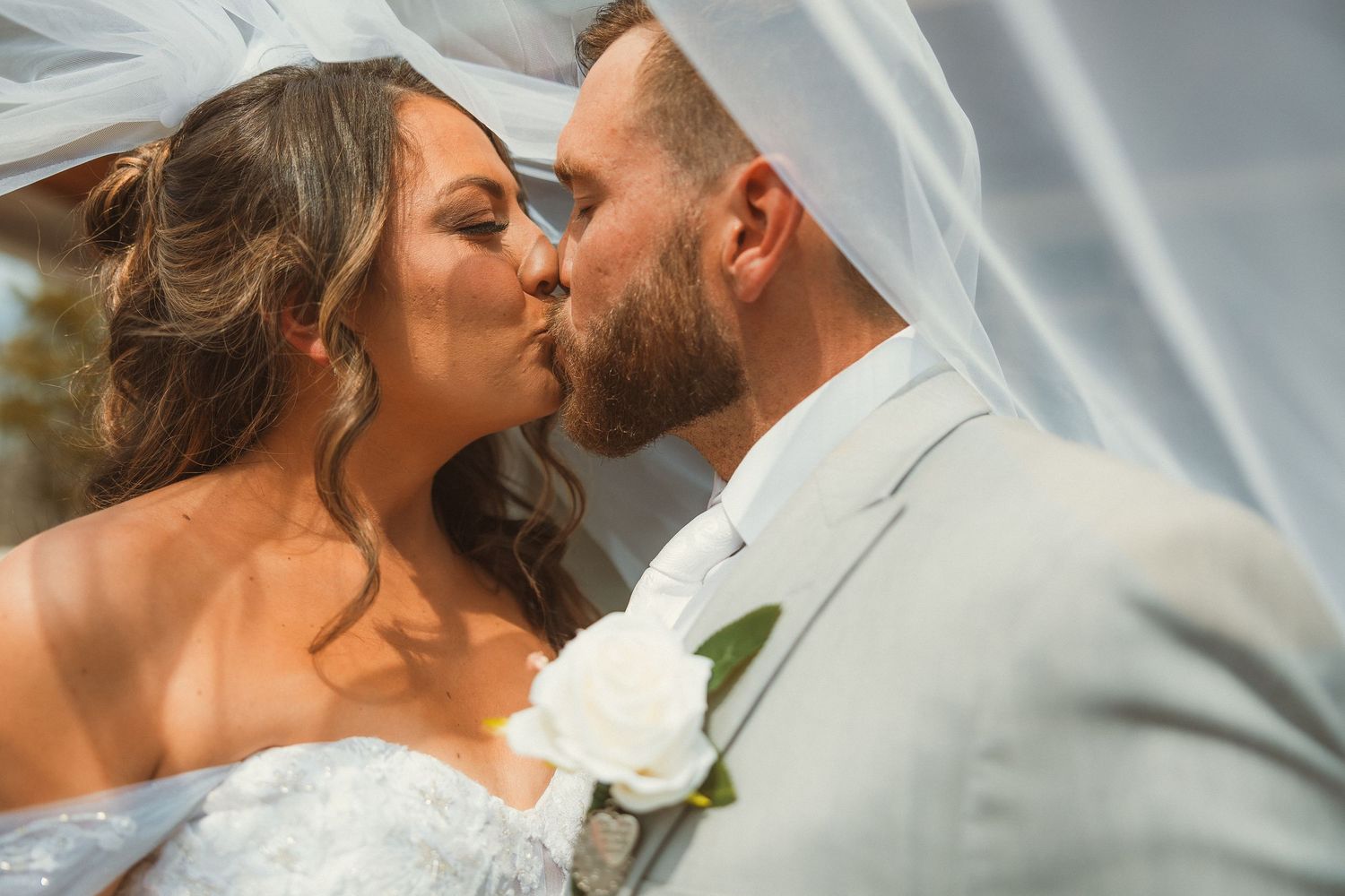 An intimate wedding portrait showing a tender moment between newlyweds.