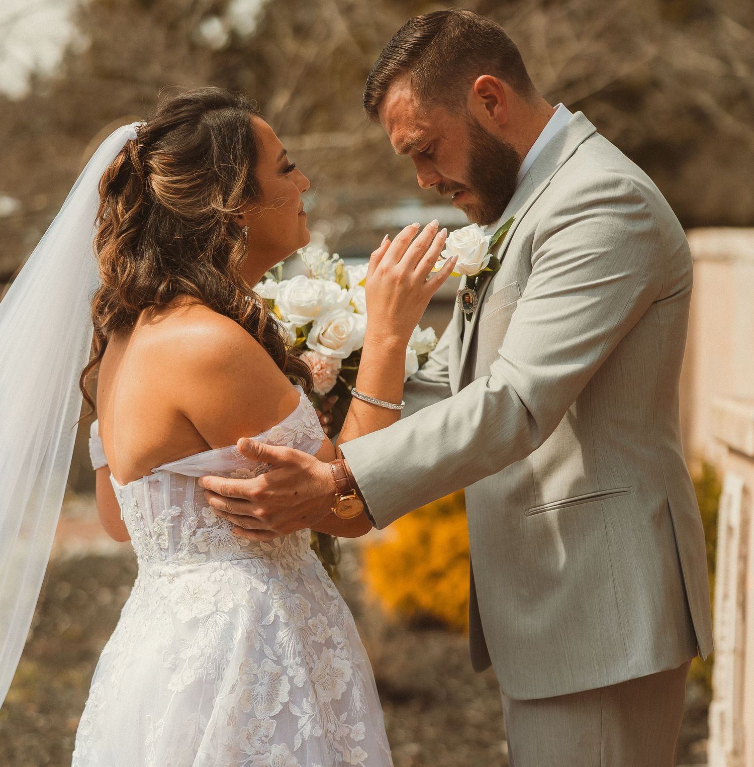 A romantic wedding moment with the couple embracing in front of a scenic backdrop.