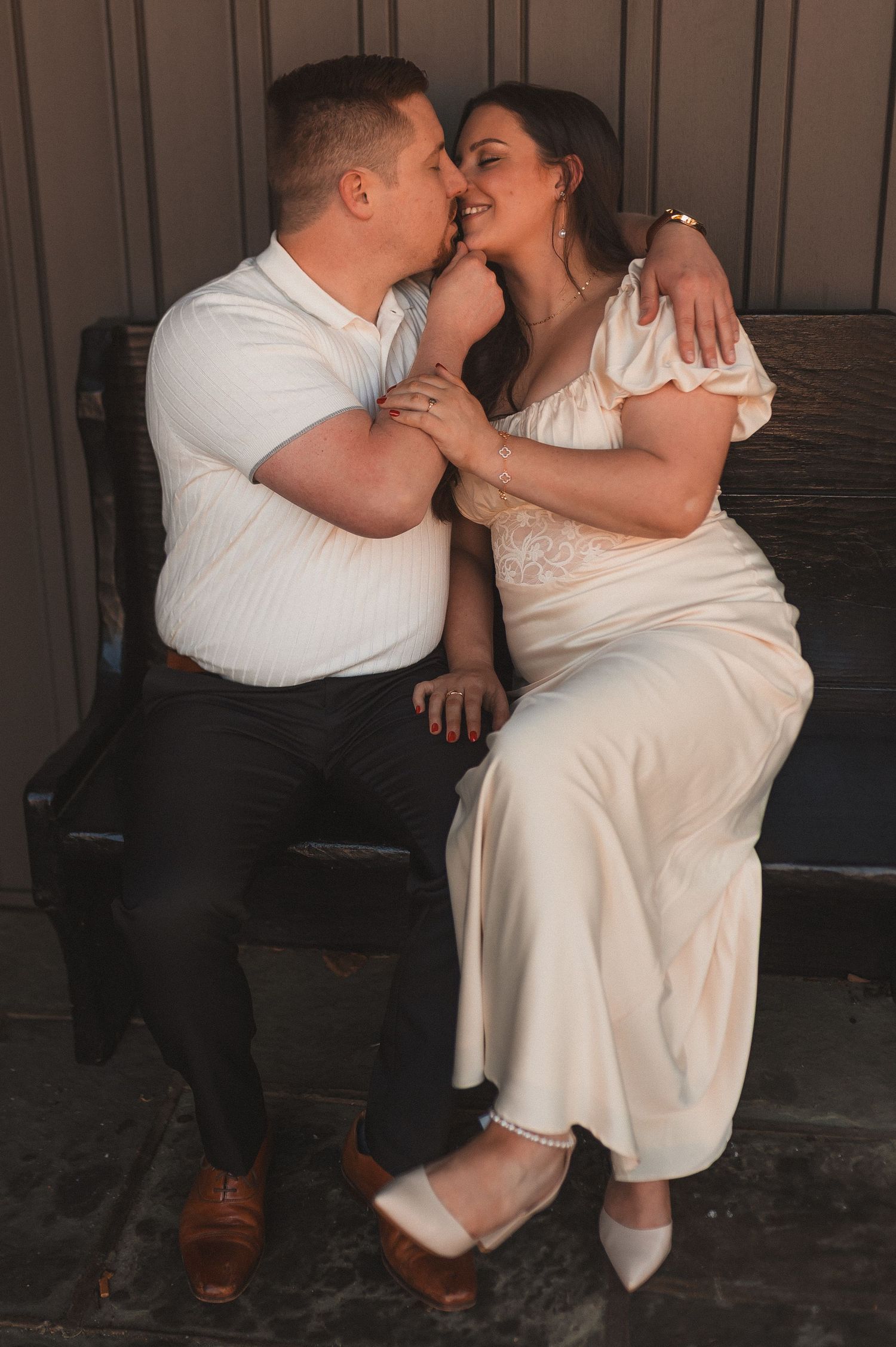 A tender moment captured in a sequence of intimate black and white photographs showing a couple embracing on a bench.