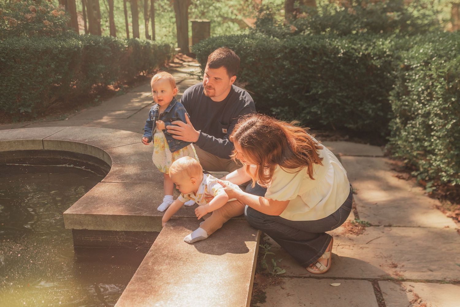 Group of people enjoying outdoor activities in a park setting while taking a rest in dappled sunlight.