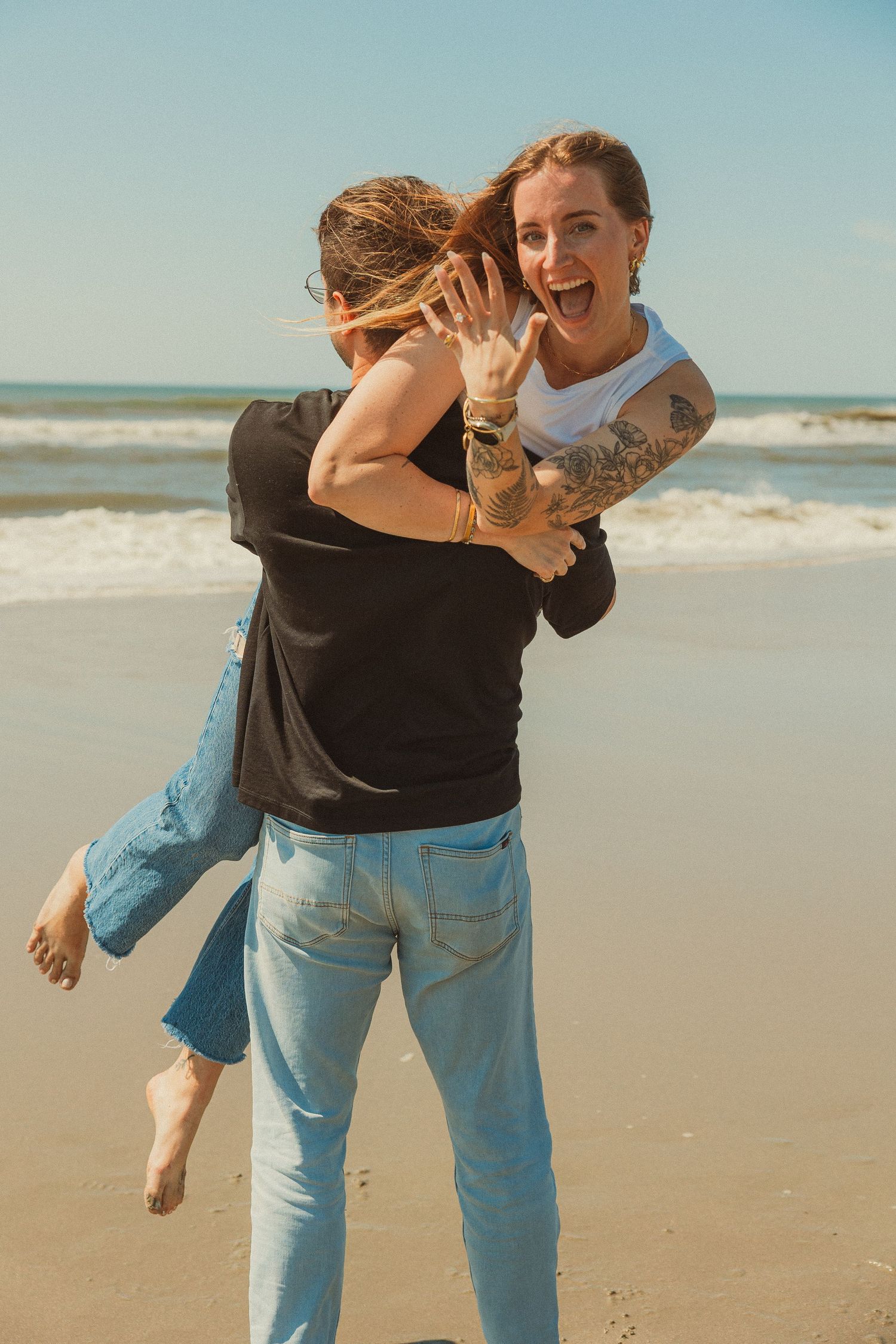 A playful couple share joyful moments together on a sunny beach in a sequence of candid interaction photos.
