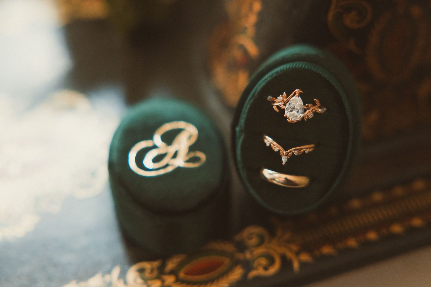 Baseball caps with embroidered team logos and designs sit on display in dark lighting.